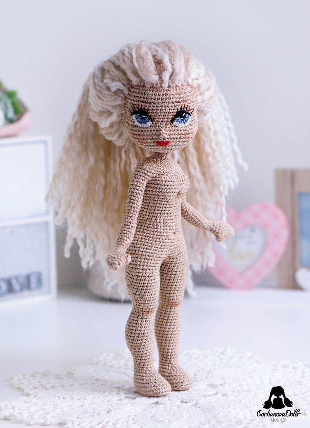 Side view of crochet doll base Michelle with white hair, head turned forward
