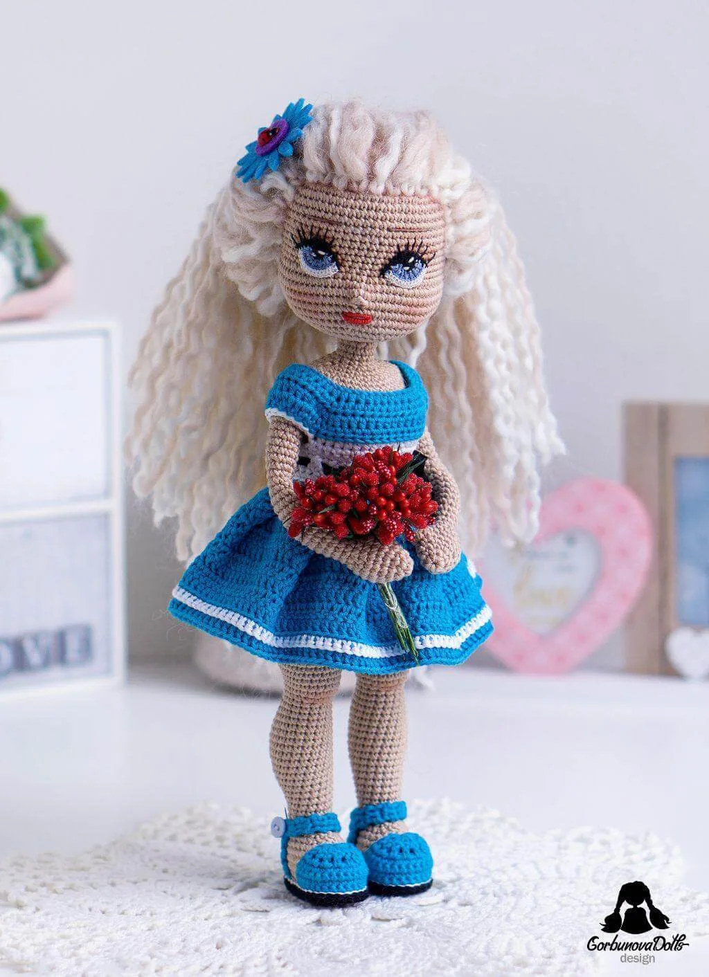 Light-skinned Michelle crochet doll wearing blue dress
