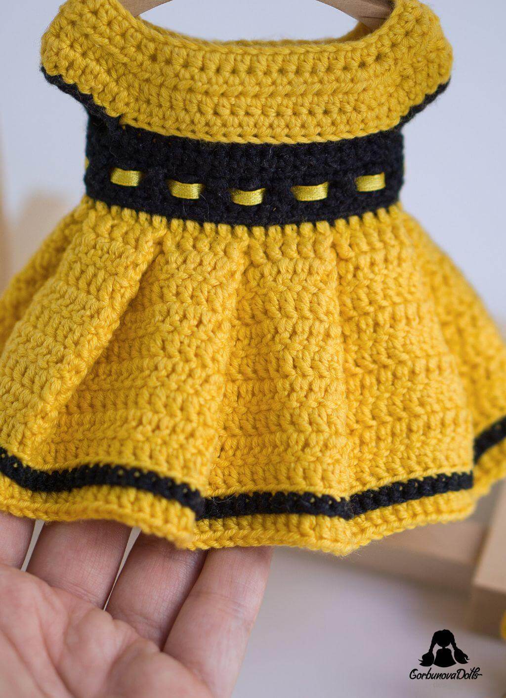 Detailed close-up of yellow crochet dress from Michelle crochet doll pattern