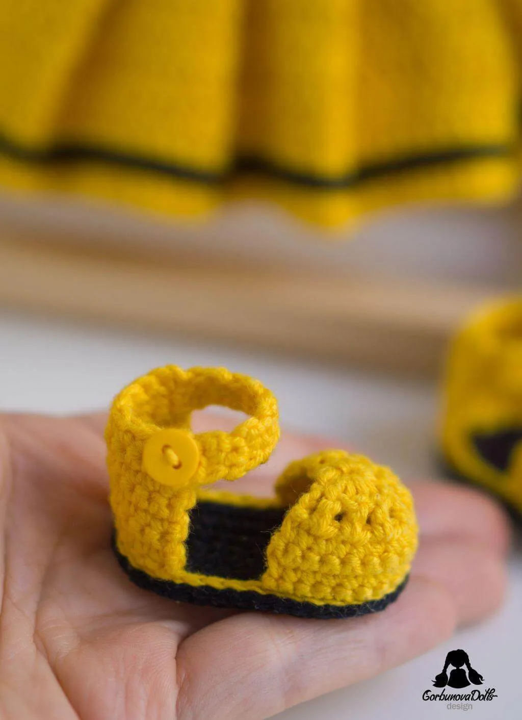 Michelle crochet doll shoe held in hand close-up