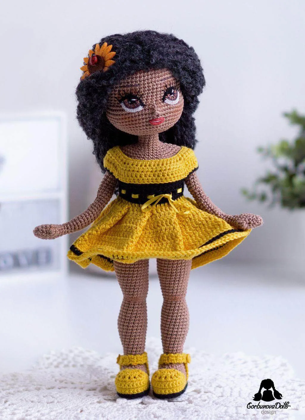 Dark-skinned Michelle crochet doll wearing yellow dress