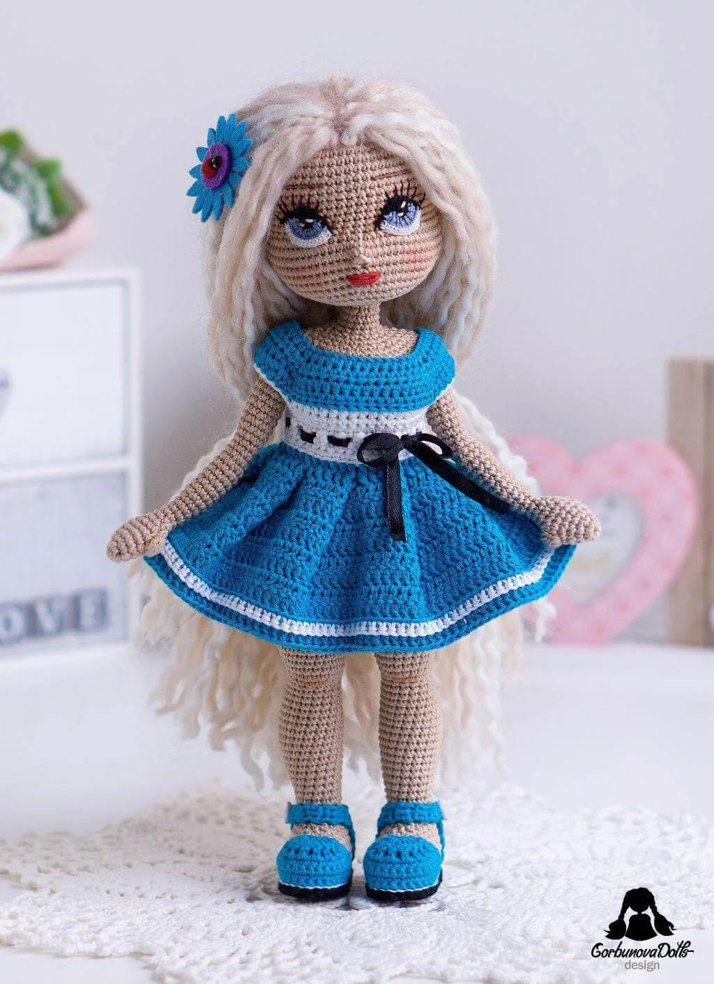 Light-skinned Michelle crochet doll wearing blue dress