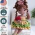 Crocheted Emily doll made from an amigurumi doll pattern, sitting on a bench and waving hello