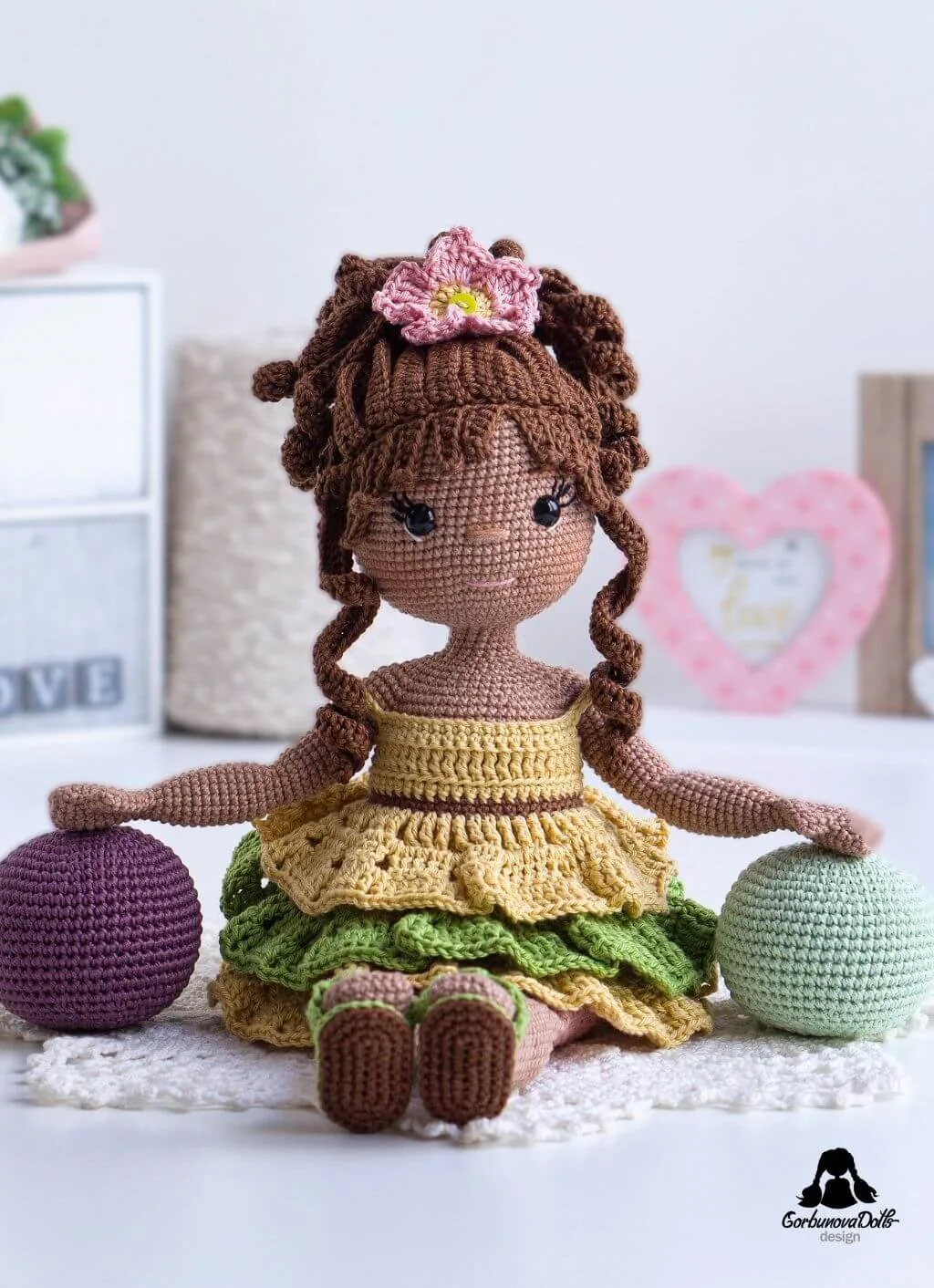 Emily crochet doll sitting on the floor, made from the amigurumi doll pattern