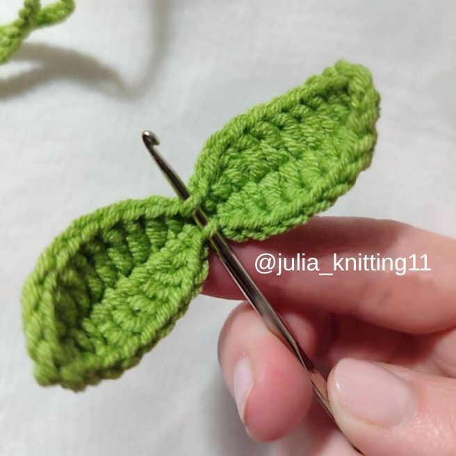 crochet keychain pattern free - hook inserted into leaf to pull through stem chain