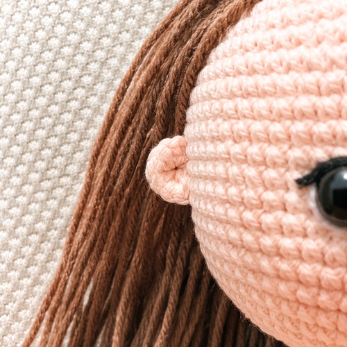 crochet base doll Arishka free amigurumi pattern – sewn ear placement on the doll head