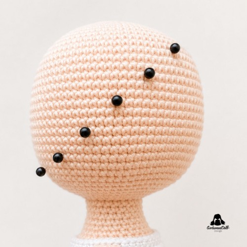crochet doll hair tutorial – side view of the hairline marked with pins