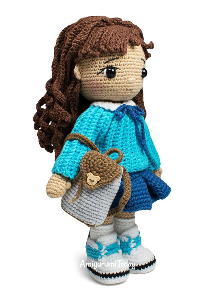 Amy crochet doll pattern with blue sweater skirt sneakers and backpack