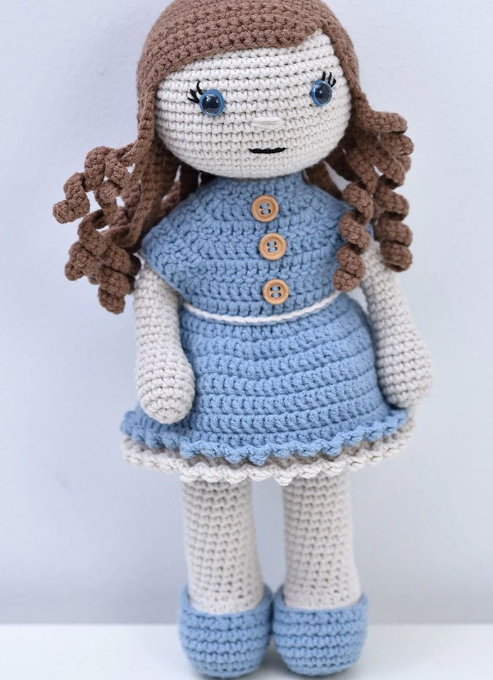 Conni crochet doll pattern with blue dress matching shoes and curly hair